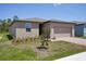 Single-story home with a two-car garage, minimal landscaping, and a brick-paved walkway at 3218 Viceroy Ct, Poinciana, FL 34759
