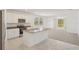 Open-concept kitchen featuring stainless steel appliances, granite countertops, and an island with sink and breakfast bar at 3218 Viceroy Ct, Poinciana, FL 34759