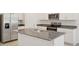 Kitchen showcasing stainless steel appliances, granite countertops, and a central island with a double sink at 3218 Viceroy Ct, Poinciana, FL 34759