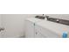 This laundry room features a white, front loading washer and dryer at 3218 Viceroy Ct, Poinciana, FL 34759
