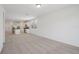 Spacious living room with neutral carpet, open to a bright kitchen with white cabinets and island at 3218 Viceroy Ct, Poinciana, FL 34759