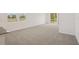 Bright living area with neutral carpet and large windows, open to scenic views and a modern kitchen at 3218 Viceroy Ct, Poinciana, FL 34759