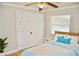 Bright bedroom with a ceiling fan, closet, and a window offering natural light at 4570 Chambliss Rd, Winter Haven, FL 33884