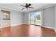 Bedroom showcasing hardwood floors, a ceiling fan, and a large window overlooking the backyard at 4570 Chambliss Rd, Winter Haven, FL 33884