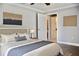 Cozy bedroom featuring hardwood floors, stylish decor and a door to a walk-in closet with built-in drawers at 4570 Chambliss Rd, Winter Haven, FL 33884