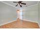 The simple bedroom features a ceiling fan, wood floors, and an open door frame at 4570 Chambliss Rd, Winter Haven, FL 33884