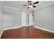 Bedroom with hardwood floors, ceiling fan, and doors leading to the hallway and potentially a closet at 4570 Chambliss Rd, Winter Haven, FL 33884