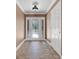 Inviting foyer with decorative glass front door, sidelights, and brick flooring at 4570 Chambliss Rd, Winter Haven, FL 33884