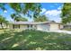 Single-story home featuring a well-kept lawn, attached garage, and inviting curb appeal at 4570 Chambliss Rd, Winter Haven, FL 33884