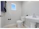 Half bathroom featuring pedestal sink, tile floors and updated fixtures at 4570 Chambliss Rd, Winter Haven, FL 33884