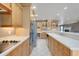 Kitchen with stainless appliances, custom cabinets and lighting, and view into living area at 4570 Chambliss Rd, Winter Haven, FL 33884
