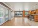 Living room with wood floors, view to kitchen, and natural light through windows and glass door at 4570 Chambliss Rd, Winter Haven, FL 33884