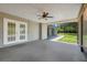 Covered patio features gray flooring, ceiling fan, and view of the spacious backyard at 4570 Chambliss Rd, Winter Haven, FL 33884