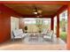 Comfortable outdoor seating on covered patio with ceiling fans and tile flooring at 4570 Chambliss Rd, Winter Haven, FL 33884