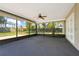 Spacious screened-in patio with a ceiling fan offering outdoor living space at 4570 Chambliss Rd, Winter Haven, FL 33884