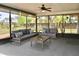 Screened-in porch with comfortable seating and a ceiling fan overlooking the backyard at 4570 Chambliss Rd, Winter Haven, FL 33884