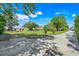 Expansive yard with lush greenery, mature trees, play structure, and a long driveway at 4570 Chambliss Rd, Winter Haven, FL 33884