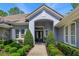 Charming single-story home featuring a manicured yard and an arched entryway at 5230 Shoreline Cir, Sanford, FL 32771