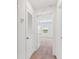 Hallway with carpet that provides access to a bedroom with a window at 836 Poppy Ln, Dundee, FL 33838