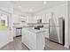 Modern kitchen with white cabinets, stainless steel appliances, and granite countertops at 836 Poppy Ln, Dundee, FL 33838