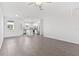 Bright, open-concept living room featuring hard surface floors and a view into the modern kitchen at 836 Poppy Ln, Dundee, FL 33838