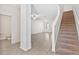 Large living room featuring hard surface floors and a view of the staircase and powder room at 836 Poppy Ln, Dundee, FL 33838