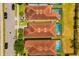 Aerial view of homes with red tile roofs and private pools in a sunny neighborhood at 8944 Sugar Palm Rd, Kissimmee, FL 34747