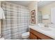 Well-lit bathroom featuring a vanity, a mirror, and a shower with a striped curtain at 8944 Sugar Palm Rd, Kissimmee, FL 34747