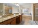 This bathroom showcases a granite countertop, double sinks, and a luxurious soaking tub at 8944 Sugar Palm Rd, Kissimmee, FL 34747