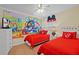Adorable bedroom featuring twin beds with Disney-themed decor and vibrant character mural at 8944 Sugar Palm Rd, Kissimmee, FL 34747