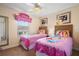 Themed bedroom featuring two beds, princess decor, and natural light, creating a cozy space at 8944 Sugar Palm Rd, Kissimmee, FL 34747