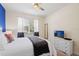 Comfortable bedroom with a large window and ceiling fan, perfect for relaxation at 8944 Sugar Palm Rd, Kissimmee, FL 34747