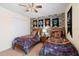 Comfortable bedroom with twin beds, Harry Potter-themed decor, and a ceiling fan at 8944 Sugar Palm Rd, Kissimmee, FL 34747