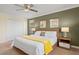 This bedroom features a modern bed frame, neutral colors, and decorative wall art at 8944 Sugar Palm Rd, Kissimmee, FL 34747