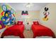Charming bedroom with twin beds and whimsical Disney-themed decor at 8944 Sugar Palm Rd, Kissimmee, FL 34747