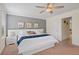 Bright bedroom with a bed, ceiling fan, neutral color palette, and ensuite bathroom at 8944 Sugar Palm Rd, Kissimmee, FL 34747