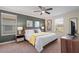 Modern bedroom with a ceiling fan, two windows and neutral color palette at 8944 Sugar Palm Rd, Kissimmee, FL 34747