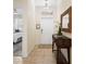 Inviting entryway featuring tiled floors, decorative mirror and console table, and an interior view of the bedroom at 8944 Sugar Palm Rd, Kissimmee, FL 34747