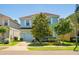 Charming two-story home with a well-maintained lawn, mature trees, and a two-car garage at 8944 Sugar Palm Rd, Kissimmee, FL 34747