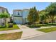 Charming two-story home with a well-maintained lawn, mature trees, and a two-car garage at 8944 Sugar Palm Rd, Kissimmee, FL 34747