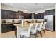 Spacious kitchen with dark wood cabinets, granite countertops, and stainless steel appliances at 8944 Sugar Palm Rd, Kissimmee, FL 34747