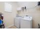 Functional laundry room with modern washer and dryer units, plus ample shelving at 8944 Sugar Palm Rd, Kissimmee, FL 34747