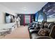 Entertainment room with large screen, movie-themed decor, and tiered seating, perfect for movie nights at 8944 Sugar Palm Rd, Kissimmee, FL 34747