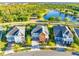 Beautiful aerial view of three homes on a sunny day, with a pond and lush green trees behind them at 9254 Reymont St, Orlando, FL 32827