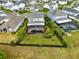 Aerial view of a home with a large backyard, screened-in pool, and well-manicured lawn at 9254 Reymont St, Orlando, FL 32827