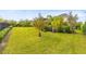 Lush backyard featuring a well-maintained lawn and tropical landscaping at 9254 Reymont St, Orlando, FL 32827