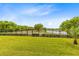 Spacious backyard with manicured lawn, fence and tranquil lake views at 9254 Reymont St, Orlando, FL 32827