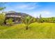 Expansive backyard with lush green lawn and screened-in pool area at 9254 Reymont St, Orlando, FL 32827