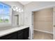 Bathroom with a large mirror, under-mount sink, and walk-in closet offering plenty of room at 9254 Reymont St, Orlando, FL 32827