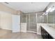 Bright bathroom featuring a glass-enclosed shower, double sink vanity and wood-look tile flooring at 9254 Reymont St, Orlando, FL 32827